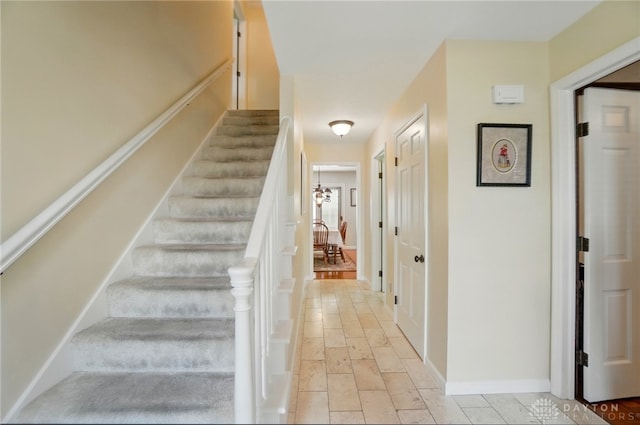 1458 Westwicke Pl, Washington Twp, OH 45459 - staircase with a chandelier, stone tile floors, and baseboards
