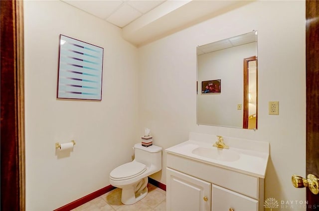 1458 Westwicke Pl, Washington Twp, OH 45459 - half bath with baseboards, toilet, vanity, a drop ceiling, and tile patterned flooring