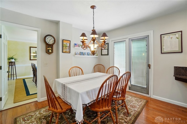 1458 Westwicke Pl, Washington Twp, OH 45459 - dining area featuring a chandelier, light wood finished floors, and baseboards