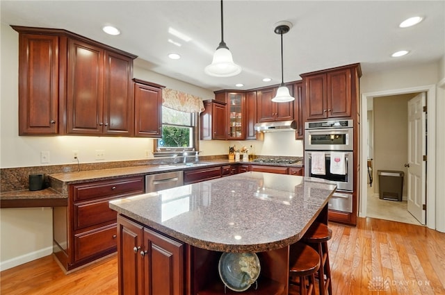 1458 Westwicke Pl, Washington Twp, OH 45459 - kitchen featuring light wood finished floors, a center island, appliances with stainless steel finishes, and under cabinet range hood
