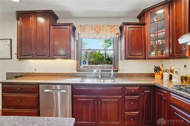 1458 Westwicke Pl, Washington Twp, OH 45459 - kitchen featuring dark stone countertops, glass insert cabinets, dishwasher, a sink, and reddish brown cabinets