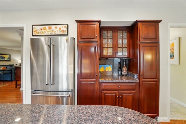 1458 Westwicke Pl, Washington Twp, OH 45459 - kitchen featuring baseboards, dark stone countertops, glass insert cabinets, backsplash, and high quality fridge