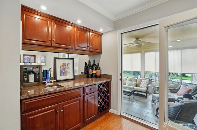 1458 Westwicke Pl, Washington Twp, OH 45459 - bar featuring ceiling fan, light wood-type flooring, bar area, ornamental molding, and a sink