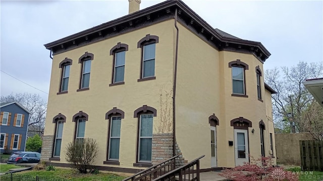 229-227 James St Unit 2, Dayton, OH 45410 - view of front of property with stucco siding and a chimney