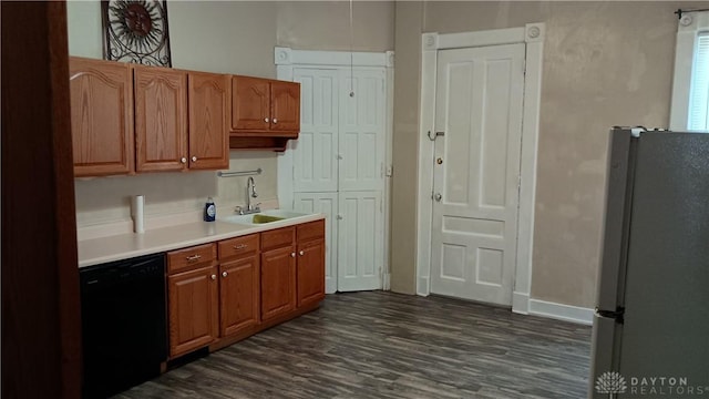 229-227 James St Unit 2, Dayton, OH 45410 - kitchen with freestanding refrigerator, black dishwasher, light countertops, dark wood finished floors, and brown cabinetry