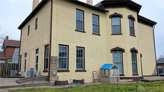 229-227 James St Unit 2, Dayton, OH 45410 - rear view of house with stucco siding and a chimney