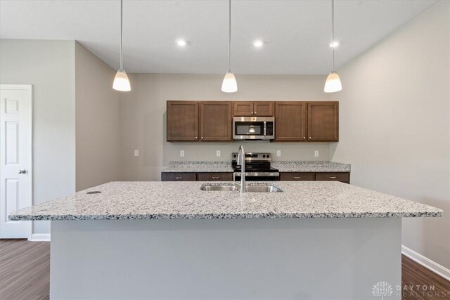 1226 Heathgate Way, Fairborn, OH 45324 - kitchen with stainless steel appliances, dark wood-style flooring, light stone countertops, decorative light fixtures, and recessed lighting