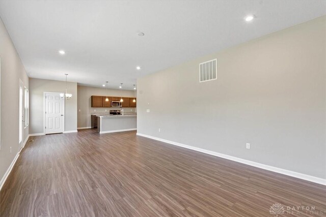 1226 Heathgate Way, Fairborn, OH 45324 - unfurnished living room featuring dark wood finished floors, recessed lighting, and a chandelier