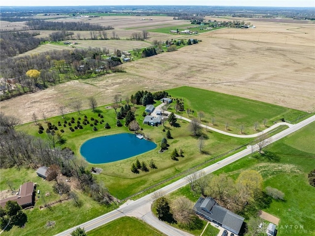 birds eye view of property with a rural view and a water view