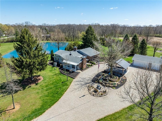 drone / aerial view featuring a water view and a view of trees