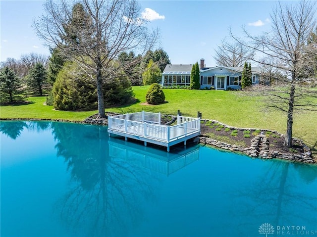 view of dock featuring a yard and a water view