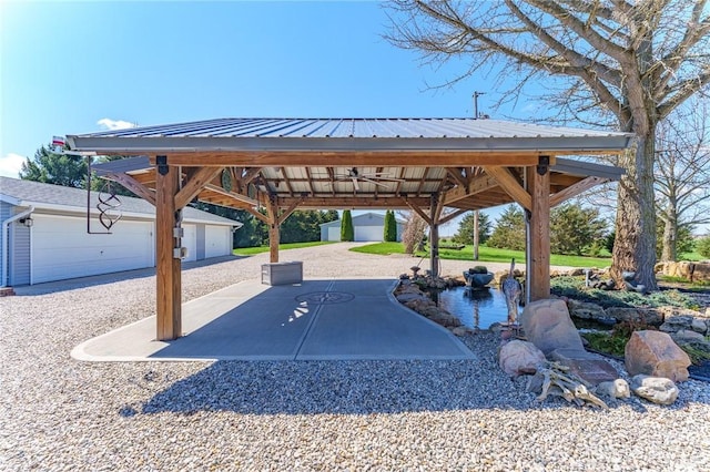 surrounding community featuring an outbuilding and a patio area