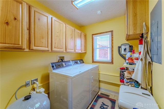 laundry room with independent washer and dryer, a textured ceiling, electric panel, baseboards, and cabinet space