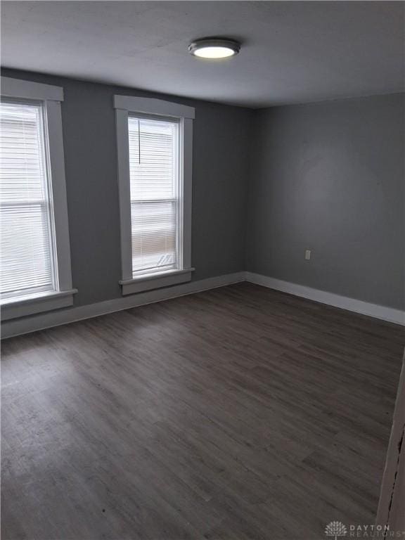217 Fillmore St, Dayton, OH 45410 - spare room featuring dark wood-style flooring and baseboards