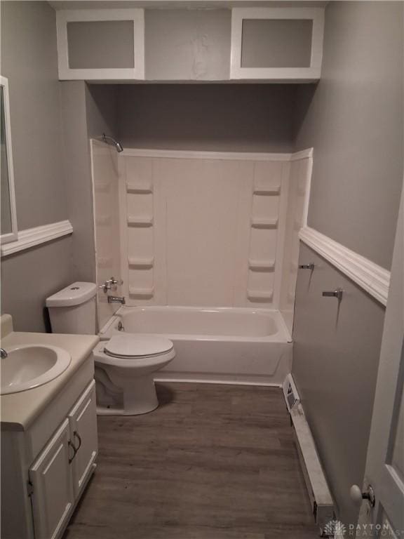 217 Fillmore St, Dayton, OH 45410 - bathroom featuring vanity, toilet, wood finished floors, and tub / shower combination