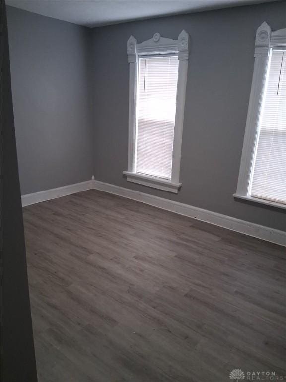 217 Fillmore St, Dayton, OH 45410 - spare room with healthy amount of natural light, dark wood-type flooring, and baseboards
