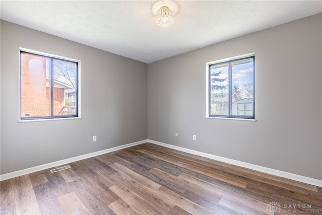 1917 Beckert Dr, Piqua, OH 45356 - spare room with plenty of natural light, wood finished floors, and baseboards