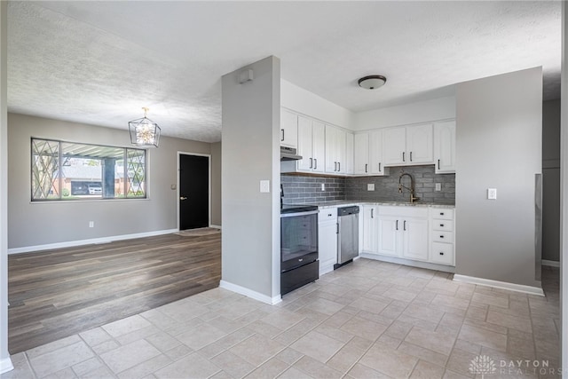1917 Beckert Dr, Piqua, OH 45356 - kitchen featuring dishwasher, electric stove, under cabinet range hood, baseboards, and backsplash