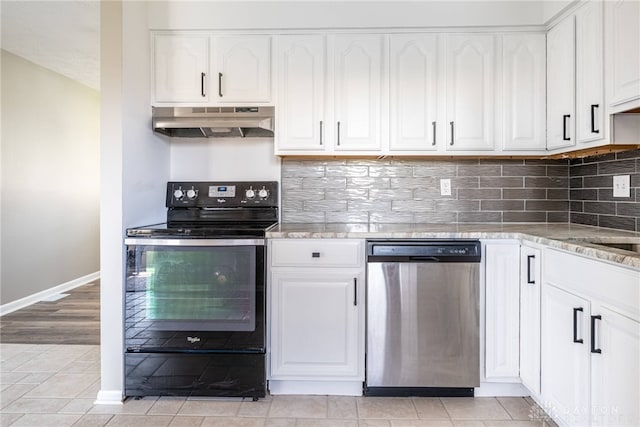 1917 Beckert Dr, Piqua, OH 45356 - kitchen with under cabinet range hood, stainless steel dishwasher, black / electric stove, white cabinets, and baseboards
