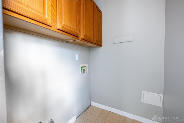 1917 Beckert Dr, Piqua, OH 45356 - washroom featuring cabinet space, hookup for a washing machine, baseboards, and light tile patterned floors
