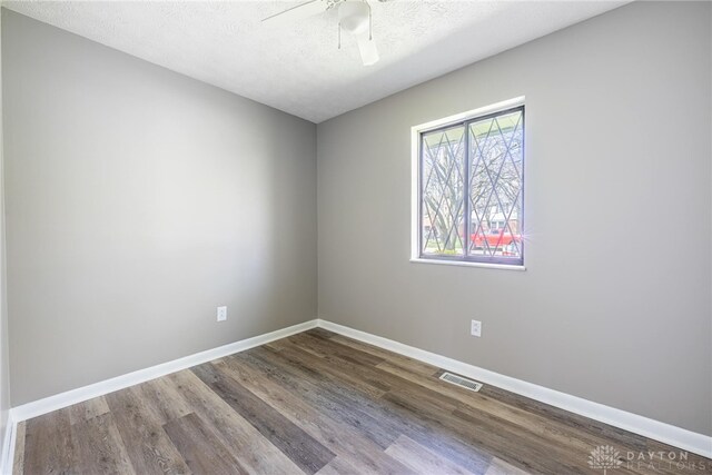 1917 Beckert Dr, Piqua, OH 45356 - spare room featuring wood finished floors, baseboards, a ceiling fan, and a textured ceiling
