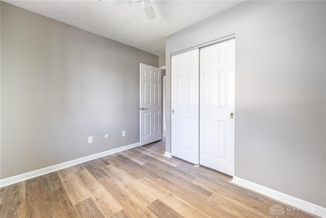 1917 Beckert Dr, Piqua, OH 45356 - unfurnished bedroom featuring light wood finished floors, baseboards, a closet, and a ceiling fan
