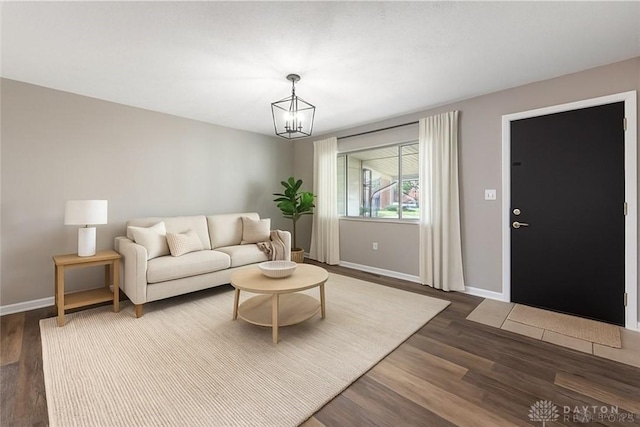 1917 Beckert Dr, Piqua, OH 45356 - living area featuring baseboards, dark wood-style floors, and a chandelier