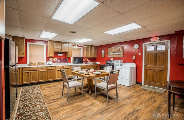 7045 US-40, New Carlisle, OH 45344 - dining room with washer / dryer, a drop ceiling, and light wood-style floors