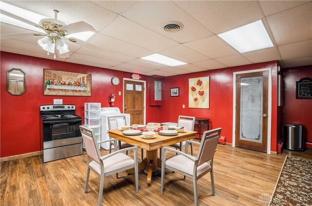7045 US-40, New Carlisle, OH 45344 - dining room with light wood-type flooring, ceiling fan, baseboards, and a drop ceiling