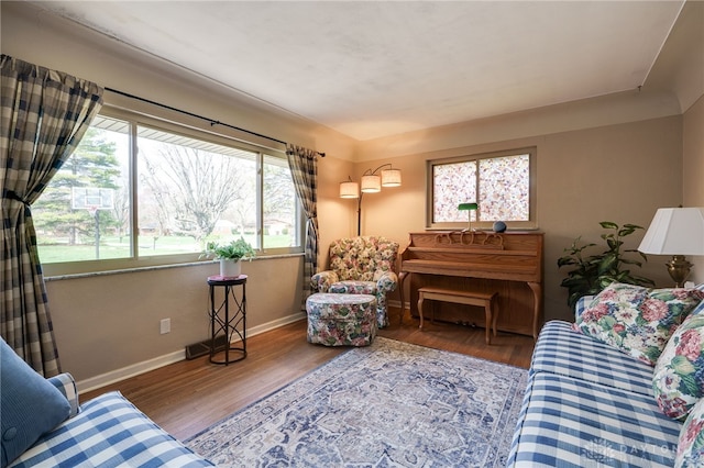 living area featuring baseboards and wood finished floors