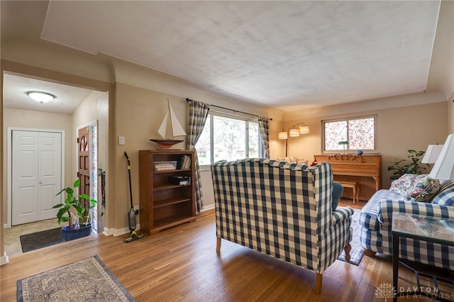 living room with light wood-type flooring and baseboards