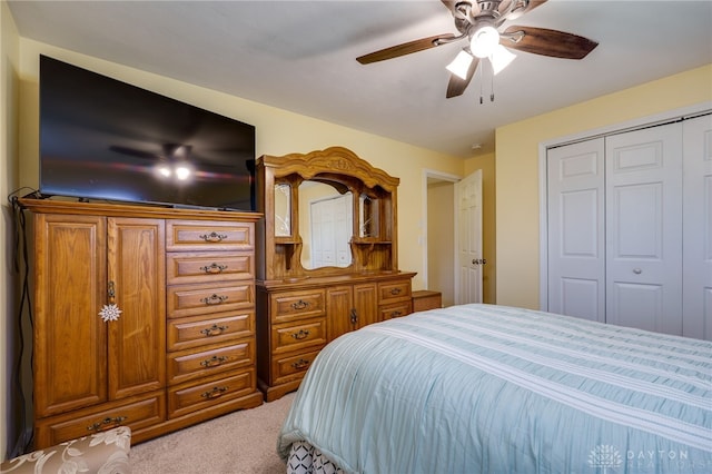 bedroom with light carpet, a closet, and ceiling fan