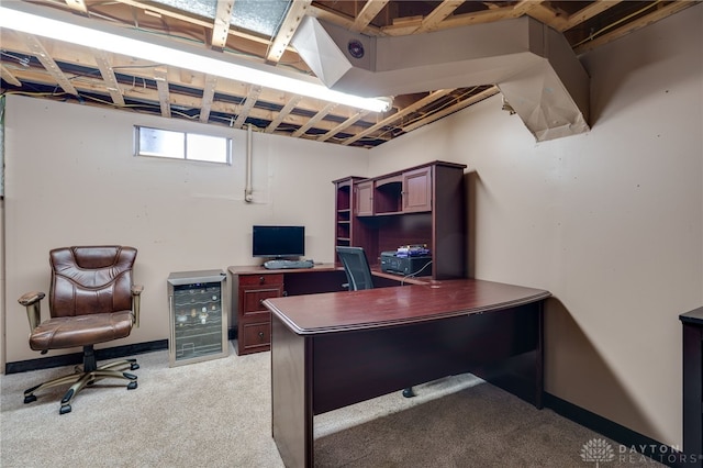home office with light carpet and beverage cooler