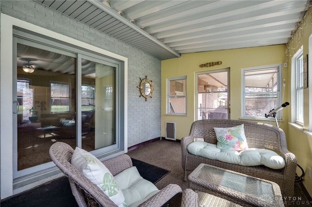sunroom featuring an outdoor living space and a ceiling fan