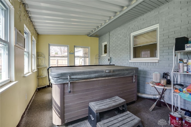 sunroom with a jacuzzi
