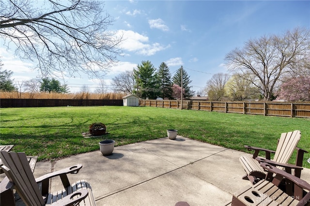 view of patio featuring a shed, a fenced backyard, and an outdoor structure