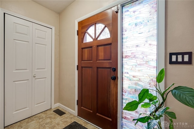foyer featuring baseboards