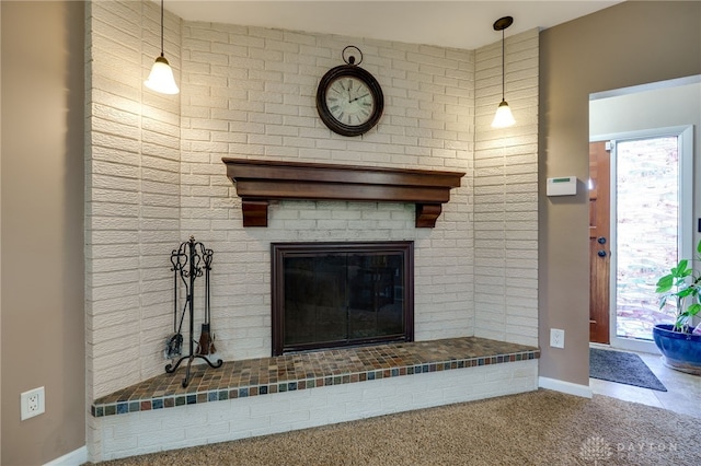details featuring baseboards, carpet, and a brick fireplace