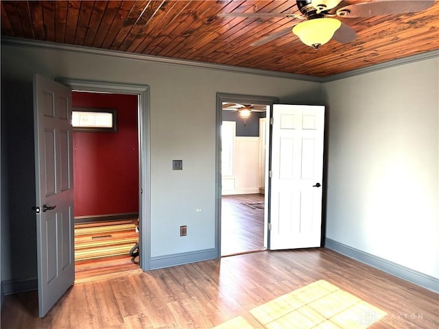 unfurnished bedroom with light wood finished floors, baseboards, and crown molding