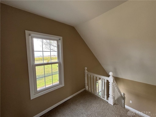 bonus room with plenty of natural light, carpet flooring, and lofted ceiling