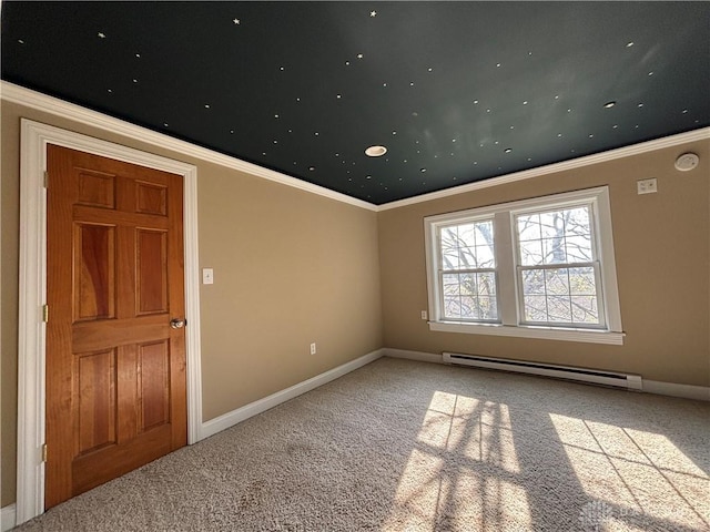 empty room featuring baseboard heating, baseboards, ornamental molding, and carpet
