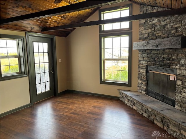 unfurnished living room featuring vaulted ceiling with beams, a fireplace, wood ceiling, and baseboards