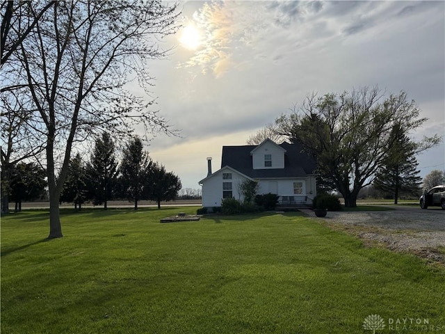 view of side of home featuring a lawn