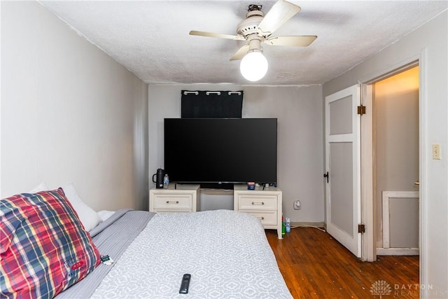 bedroom featuring dark wood-style flooring and ceiling fan