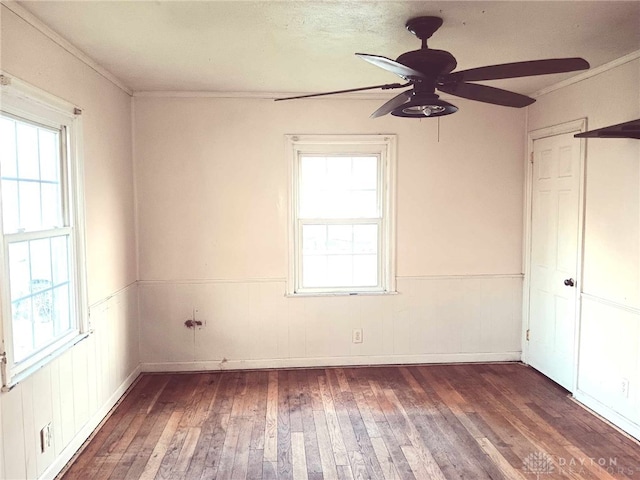 2025 Malcom Dr, Dayton, OH 45420 - empty room featuring wood-type flooring, ceiling fan, a wainscoted wall, and ornamental molding