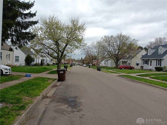 2025 Malcom Dr, Dayton, OH 45420 - view of asphalt street with a residential view, sidewalks, and curbs
