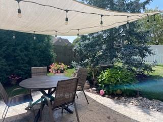 view of patio with fence and outdoor dining area