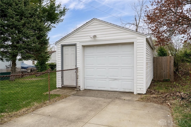detached garage with driveway and fence