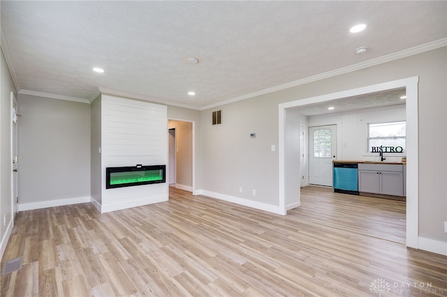 unfurnished living room featuring a fireplace, light wood finished floors, baseboards, and recessed lighting