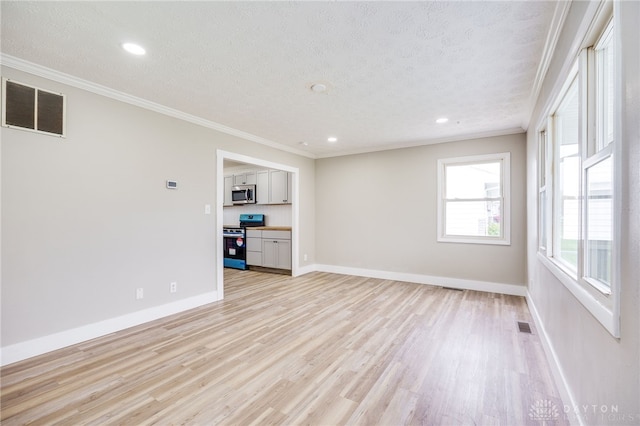 unfurnished living room featuring ornamental molding, a textured ceiling, visible vents, and light wood-style floors